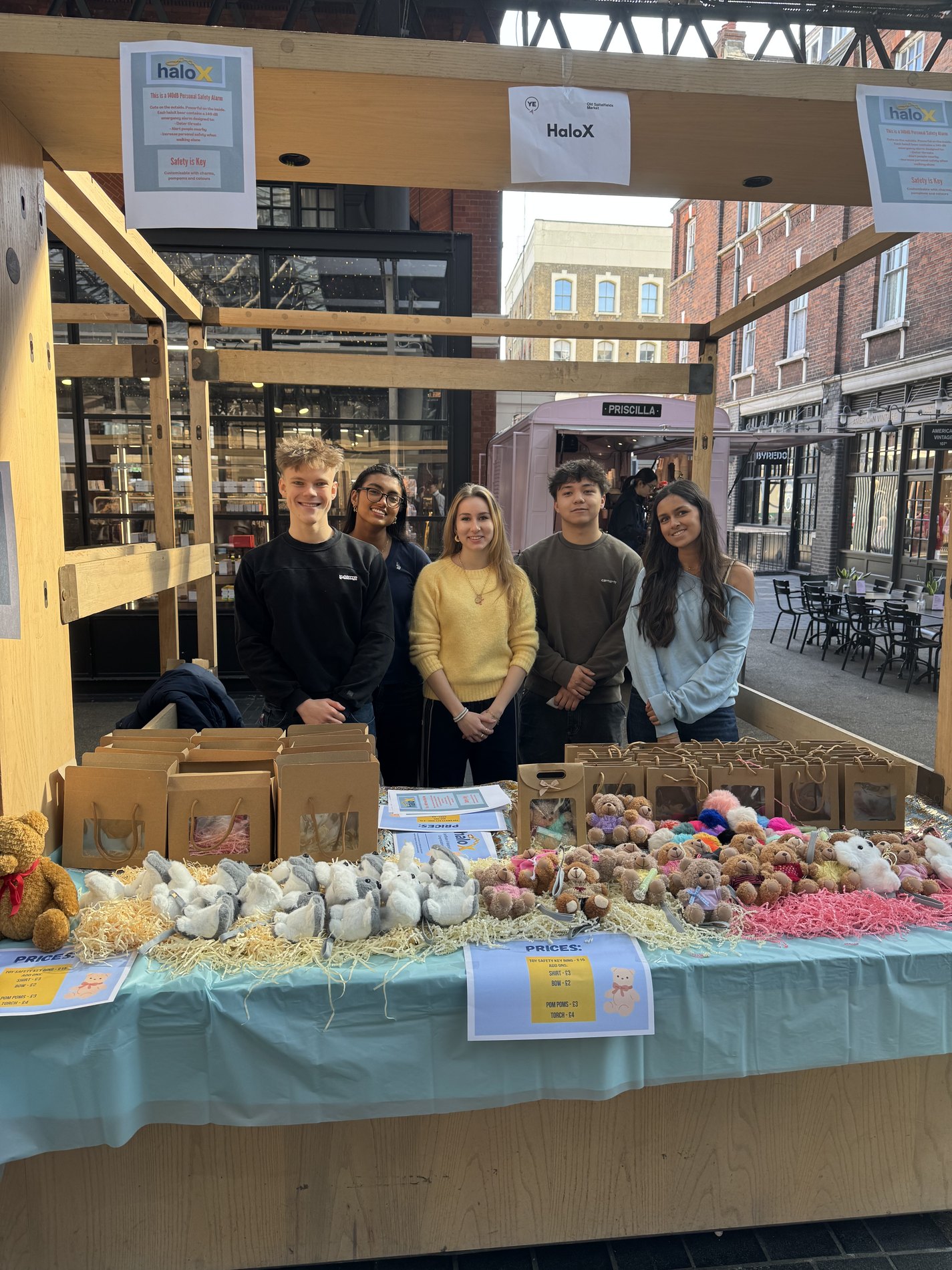 The HaloZen team at their market stall surrounded by plush products